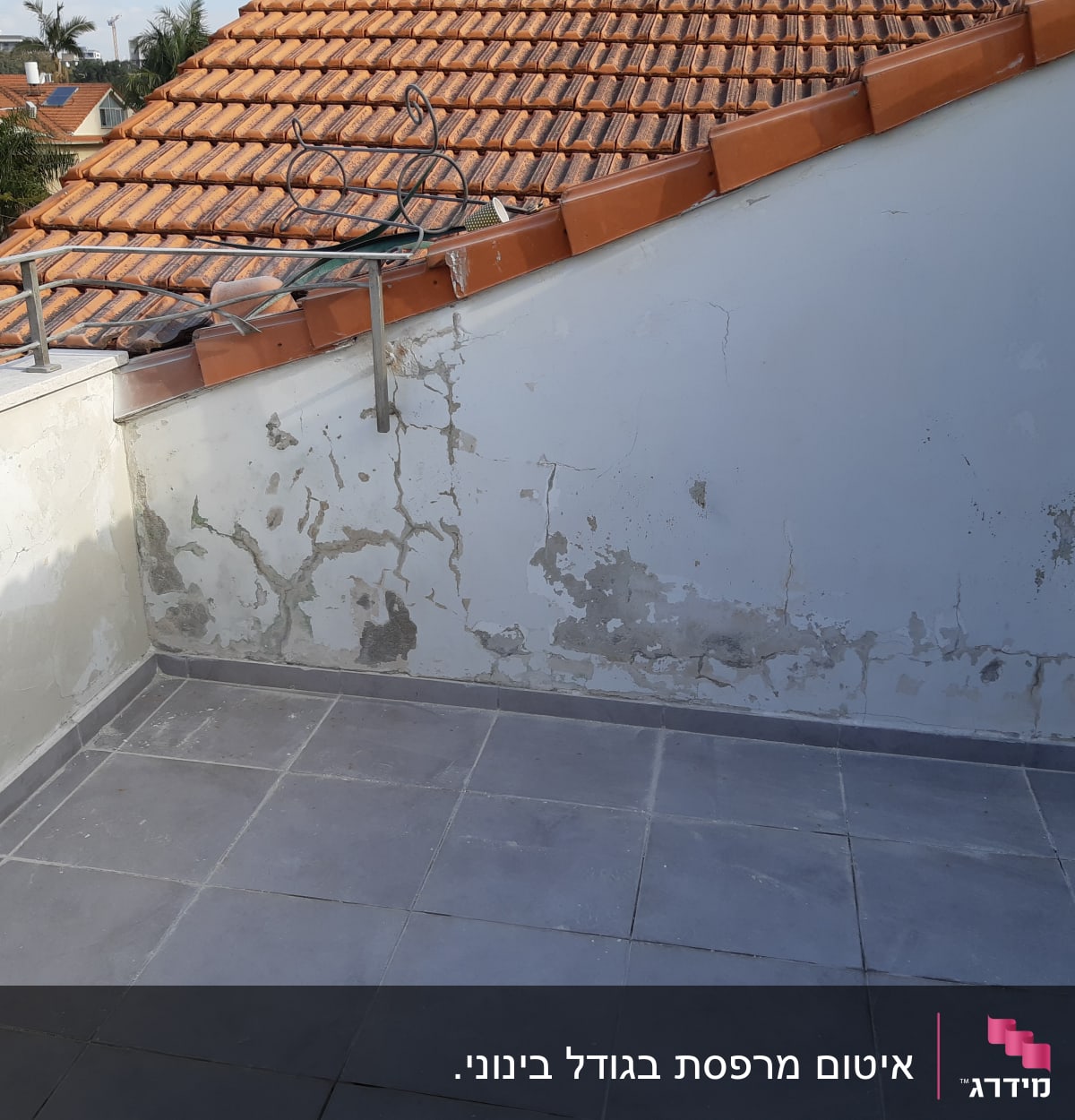 קיר עם סדקים ורטיבות על גג רעפים